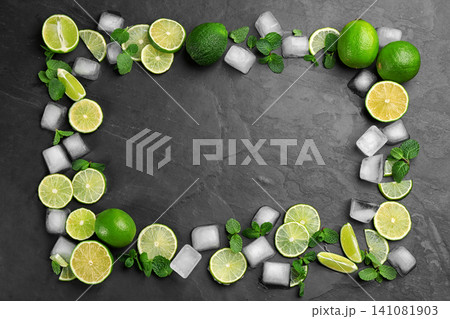 Frame made of lime slices, mint and ice on black table, top view with space for text 141081903