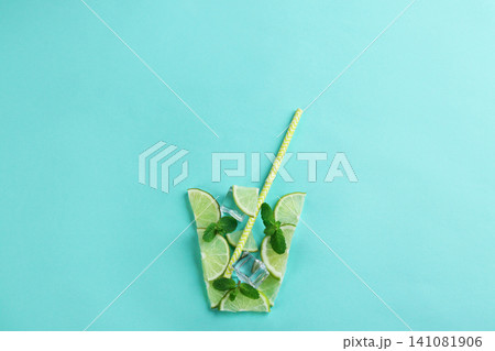 Creative lemonade layout with lemon slices, mint and ice on turquoise background, top view 141081906