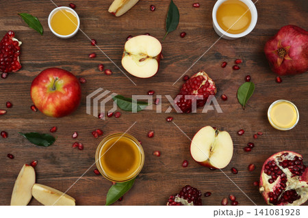 Flat lay composition with honey and fruits on wooden table. Rosh Hashanah holiday Flat lay composition with honey and fruits on wooden table. Rosh Hashanah holiday 141081928