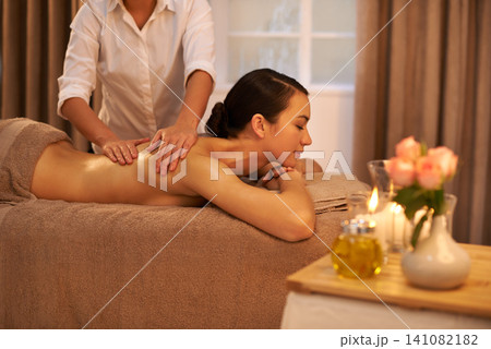 Smile, back massage and female person at spa, treatment and wellness for holistic care. Calm, peace and muscle tension relief with reflexology from therapist, beauty salon and masseur for body health Smile, back massage and female person at spa, treatment and wellness for holistic care. Calm, peace and muscle tension relief with reflexology from therapist, beauty salon and masseur for body health 141082182