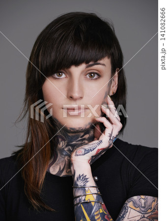 Woman, portrait and stylist with tattoo for facial treatment, style or body art on a gray studio background. Face of female person, young model or smile for design, creativity or cool beauty artist 141082666