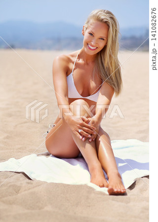 Travel, beach and woman sunbathing in bikini on tropical vacation, adventure or holiday for paradise. Happy, portrait and person in swimwear on towel by ocean for summer weekend trip in Australia. Travel, beach and woman sunbathing in bikini on tropical vacation, adventure or holiday for paradise. Happy, portrait and person in swimwear on towel by ocean for summer weekend trip in Australia. 141082676
