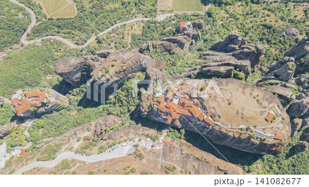 Horizontal top down aerial drone shot of the famous holy trinity monastery built on top of a massive sandstone rock pillar in meteora greece on a sunny summer day 141082677
