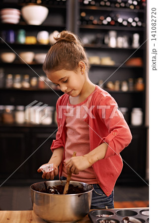 Girl, bake and learning with kid, food and ingredients with utensils and child development with dessert. Home, apartment and kitchen with recipe and prepare with pan and cupcake with joy and mixture Girl, bake and learning with kid, food and ingredients with utensils and child development with dessert. Home, apartment and kitchen with recipe and prepare with pan and cupcake with joy and mixture 141082720