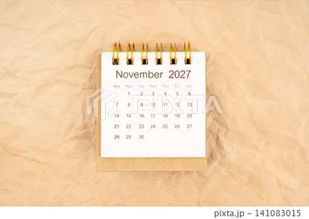 November 2027 mini desk calendar on old paper. November 2027 mini desk calendar on old paper. 141083015