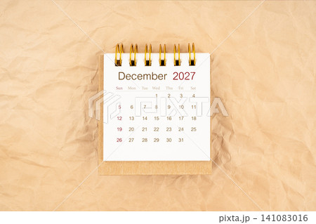 December 2027 mini desk calendar on old paper. December 2027 mini desk calendar on old paper. 141083016
