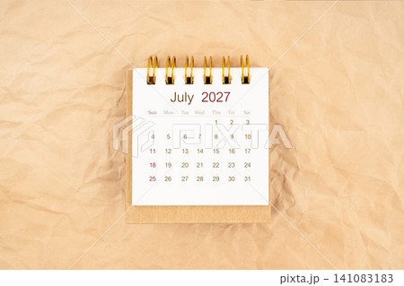 July 2027 mini desk calendar on old paper. July 2027 mini desk calendar on old paper. 141083183
