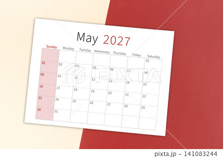 May 2027 calendar page on yellow and red background. May 2027 calendar page on yellow and red background. 141083244