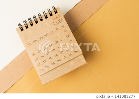 Blank desk calendar for May 2027 on brown tone background. Blank desk calendar for May 2027 on brown tone background. 141083277