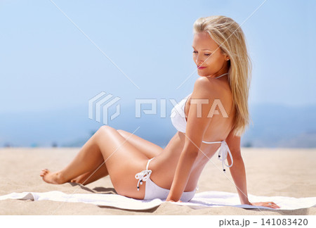 Woman, smile and beach in bikini for swimwear, tan and summer for relax and break for holiday. Young person and attractive with towel on sand for travel, sunshine and trip for season on mockup Woman, smile and beach in bikini for swimwear, tan and summer for relax and break for holiday. Young person and attractive with towel on sand for travel, sunshine and trip for season on mockup 141083420