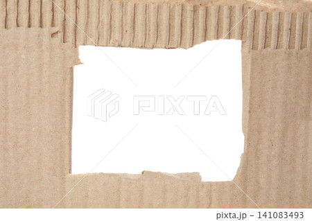 Hole in brown cardboard on white background Hole in brown cardboard on white background 141083493