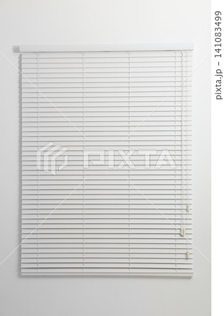 Modern window with closed blinds in room Modern window with closed blinds in room 141083499
