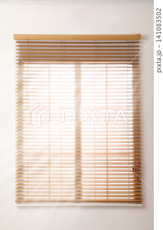 Modern window with open wooden blinds indoors Modern window with open wooden blinds indoors 141083502