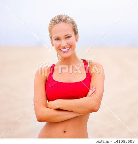 Woman, portrait and exercise on the beach with arms crossed, confidence and smile with wellness and outdoor. Fitness, athlete and sports with happiness for health, marathon or race for cardio workout 141083605