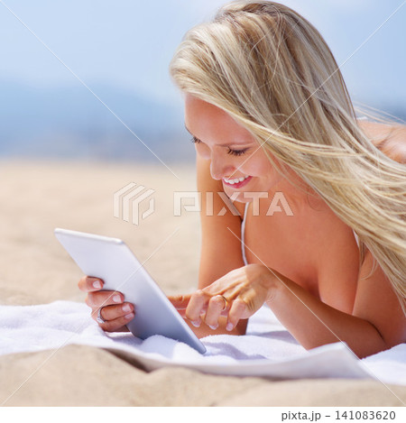 Woman, tablet and beach holiday to relax, female person and ocean and smile with technology for entertainment. Browse, social media or streaming online on vacation, happy or calm on Miami summer trip 141083620