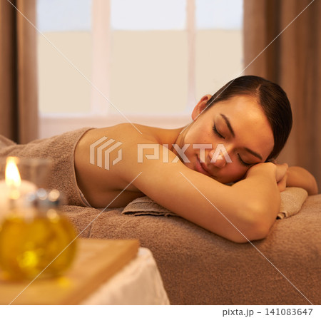 Peace, sleep and woman on massage table at spa for self care, stress relief and natural wellness. Female person, zen and calm at luxury hotel for body health, hospitality and spiritual healing 141083647