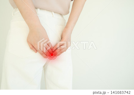 Woman suffering from anal pain and discomfort. Cause of pain include hemorrhoid, anal fissure, diarrhea, constipation or Crohn's disease. Gastrointestinal system concept. Woman suffering from anal pain and discomfort. Cause of pain include hemorrhoid, anal fissure, diarrhea, constipation or Crohn's disease. Gastrointestinal system concept. 141083742