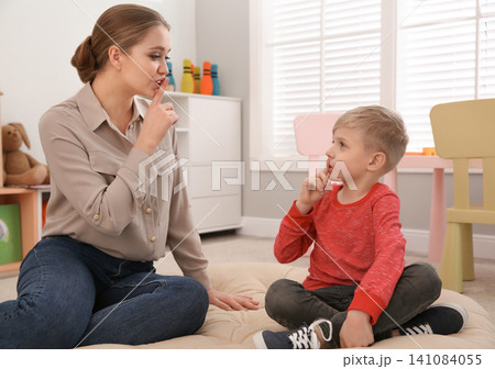 Speech therapist working with little boy in office Speech therapist working with little boy in office 141084055