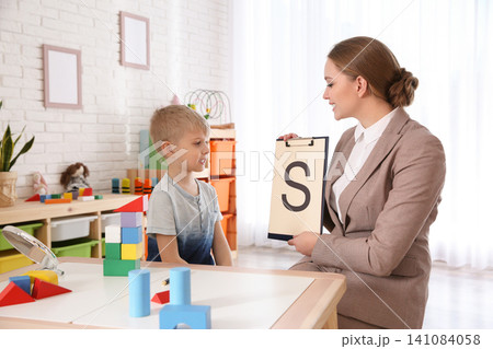 Speech therapist working with little boy in office Speech therapist working with little boy in office 141084058