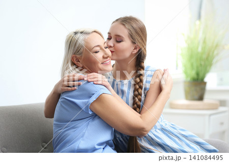 Mother and her adult daughter spending time together at home Mother and her adult daughter spending time together at home 141084495