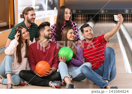 Group of friends taking selfie in bowling club Group of friends taking selfie in bowling club 141084824