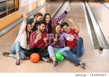 Group of friends taking selfie in bowling club Group of friends taking selfie in bowling club 141084825