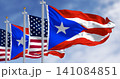 Flags of Puerto Rico waving with the United States flags on a clear day 141084851