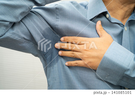 Man with sweaty arm pit on shirt when working in office, Hyperhidrosis sweating. 141085101