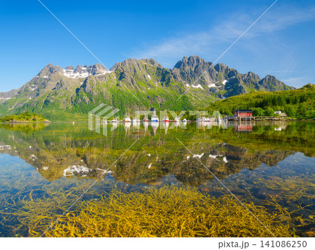 Fishing boats and ships anchored in a sea bay at Lofoten islands, Norway. Fishing boats and ships anchored in a sea bay at Lofoten islands, Norway. 141086250
