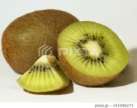 Juicy kiwi fruit slice close-up on white. Juicy kiwi fruit slice close-up on white. 141086275