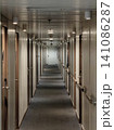 Long narrow corridor inside a cruise ship or hotel with wooden doors. 141086287