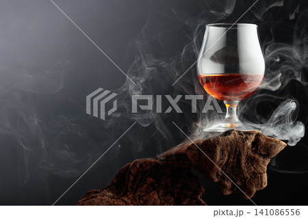Smoked old-fashioned cocktail on weathered driftwood. Smoked old-fashioned cocktail on weathered driftwood. 141086556