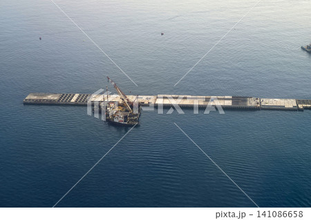 genoa new dam seawall construction aerial view while landing to airport genoa new dam seawall construction aerial view while landing to airport 141086658