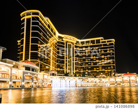 Beautiful night view of Wynn Palace Performance Lake displays a water, music, and light show, is a hotel casino resort on the Cotai Strip in Macau, China. Beautiful night view of Wynn Palace Performance Lake displays a water, music, and light show, is a hotel casino resort on the Cotai Strip in Macau, China. 141086898