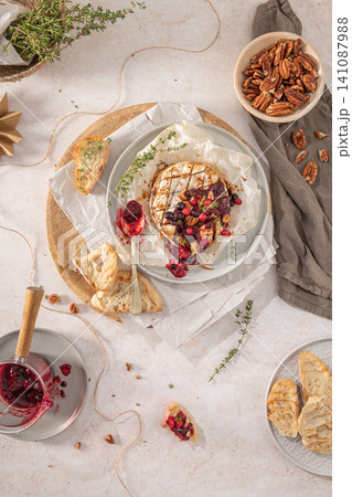 Baked or fried grilled Camembert or brie cheese with berry sauce or jam. Gourmet traditional Breakfast close up. Baked or fried grilled Camembert or brie cheese with berry sauce or jam. Gourmet traditional Breakfast close up. 141087988