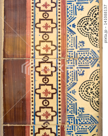 Close-up of traditional Portuguese ceramic tiles featuring geometric patterns in brown and blue colors, showcasing historic azulejo architecture 141088137