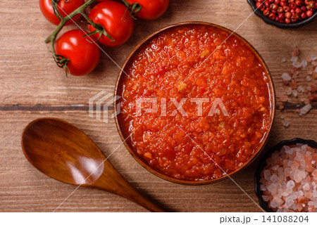 Red tomato Bolognese sauce with spices, salt, pepper, and herbs. A red sauce Red tomato Bolognese sauce with spices, salt, pepper, and herbs. A red sauce 141088204