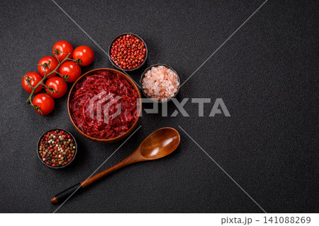 Grated beetroot with salt and spices as an ingredient for borscht or a vegan salad. Grated beetroot Grated beetroot with salt and spices as an ingredient for borscht or a vegan salad. Grated beetroot 141088269