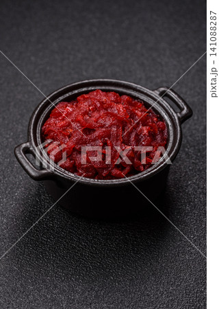 Grated beetroot with salt and spices as an ingredient for borscht or a vegan salad. Grated beetroot Grated beetroot with salt and spices as an ingredient for borscht or a vegan salad. Grated beetroot 141088287