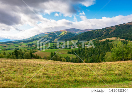 countryside meadow in mountain landscape of ukraine. lush grass fields at the foot of borzhava ridge. beautiful view of transcarpathian scenery in early autumn countryside meadow in mountain landscape of ukraine. lush grass fields at the foot of borzhava ridge. beautiful view of transcarpathian scenery in early autumn 141088304
