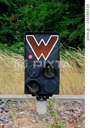 Vintage black railway wait signal with white letter W standing by the tracks Vintage black railway wait signal with white letter W standing by the tracks 141088316
