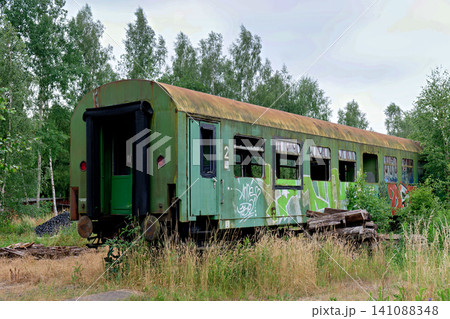 Abandoned green passenger train carriage with graffiti on old railway track Abandoned green passenger train carriage with graffiti on old railway track 141088348