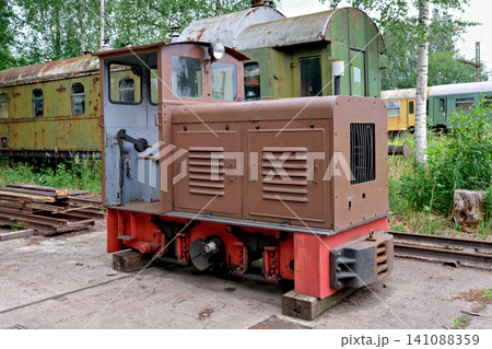 Small vintage brown diesel locomotive parked at an outdoor railway museum exhibition Small vintage brown diesel locomotive parked at an outdoor railway museum exhibition 141088359