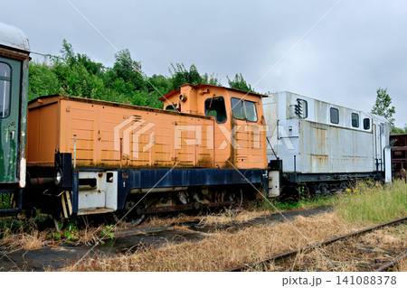 Vintage diesel locomotives abandoned on old railway station tracks side view 141088378