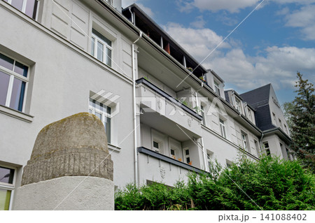 Low angle view of modern white residential apartment building Low angle view of modern white residential apartment building 141088402