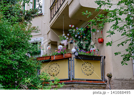 Charming cozy balcony decorated with flower pots and colorful lanterns Charming cozy balcony decorated with flower pots and colorful lanterns 141088495