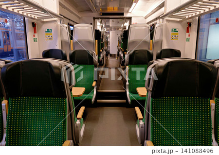 Interior of clean train car with green seats and tables Interior of clean train car with green seats and tables 141088496