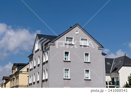 Modern gray apartment building facade against a clear blue sky on a sunny day. Modern gray apartment building facade against a clear blue sky on a sunny day. 141088541