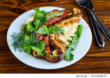 Healthy omelet served with salmon and fresh herb garnish Healthy omelet served with salmon and fresh herb garnish 141088637