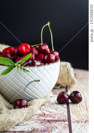 Natural sweet cherries with mint leaves and copy space Natural sweet cherries with mint leaves and copy space 141088650